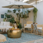 Cozy backyard with outdoor furniture, plants, warm lighting, cushions, and simple decor for relaxing evenings.