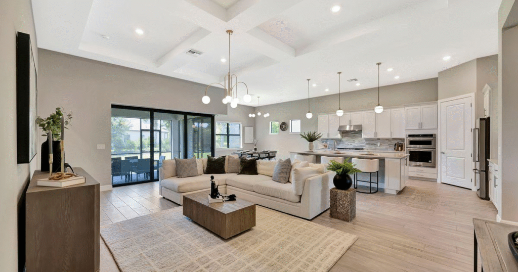 Modern open-plan living room and kitchen with stylish furniture and organized, tidy spaces.